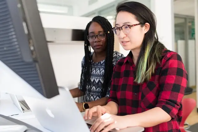 two women looking at laptop screen