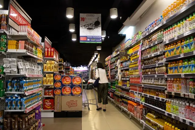 woman pushing cart in supermarket