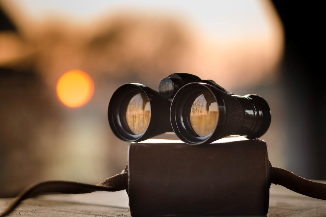 Binoculars on a book at sunset.