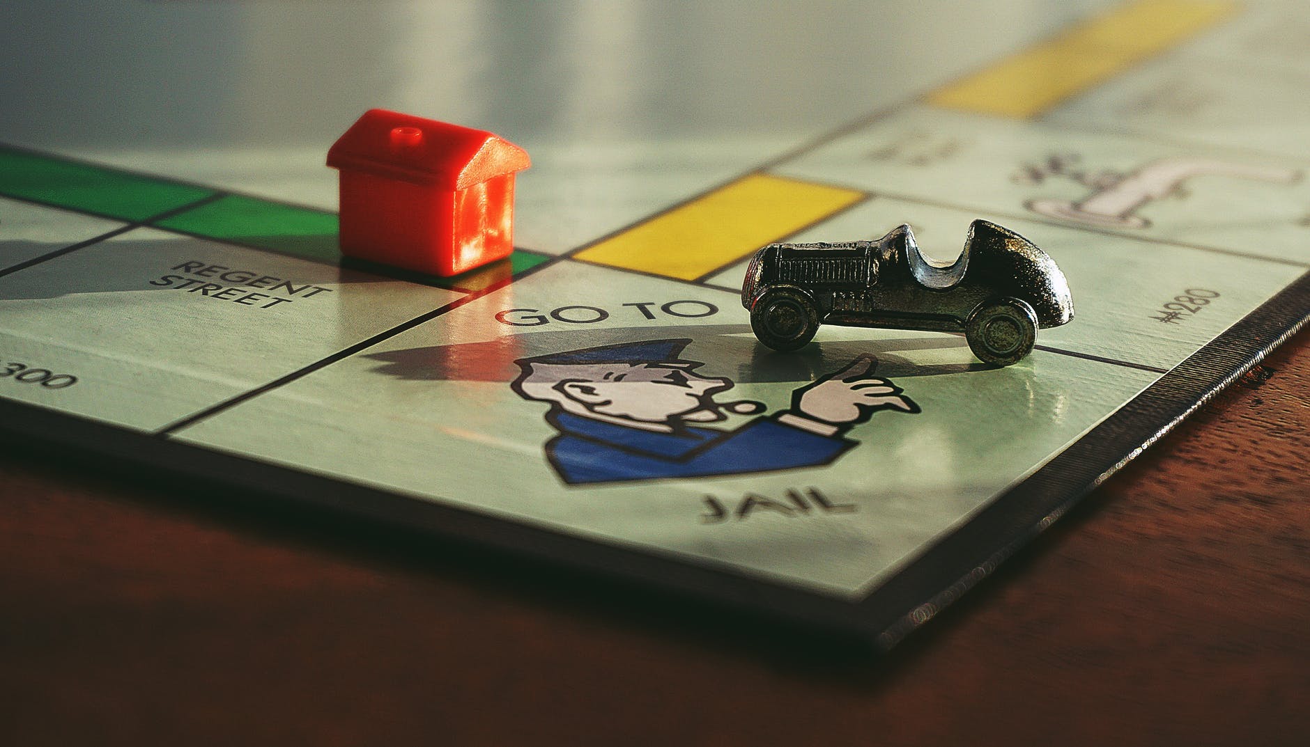 Photo of monopoly board game showing the car going to jail
