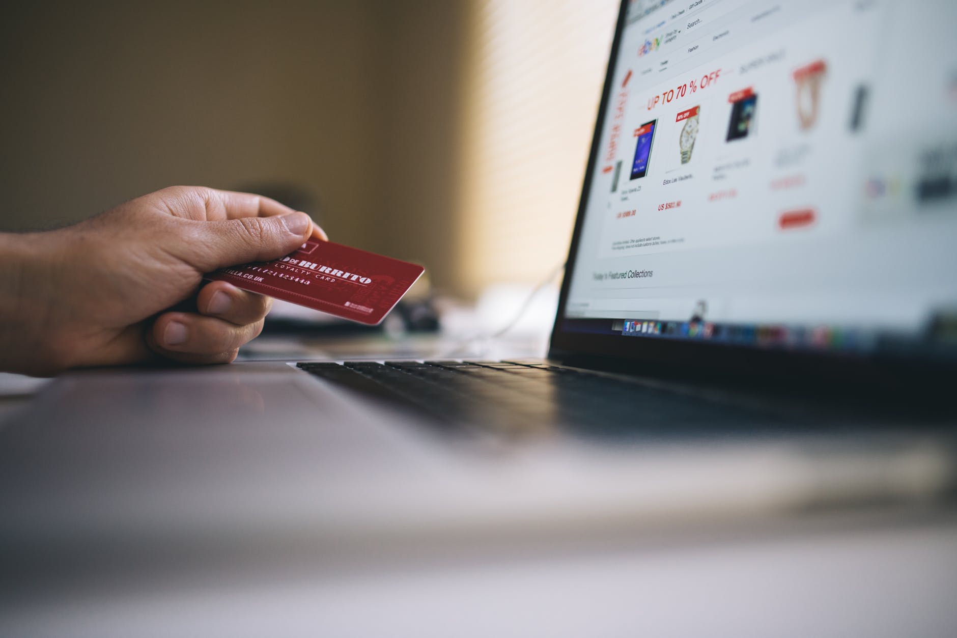 A man using a payment card to do some online shopping