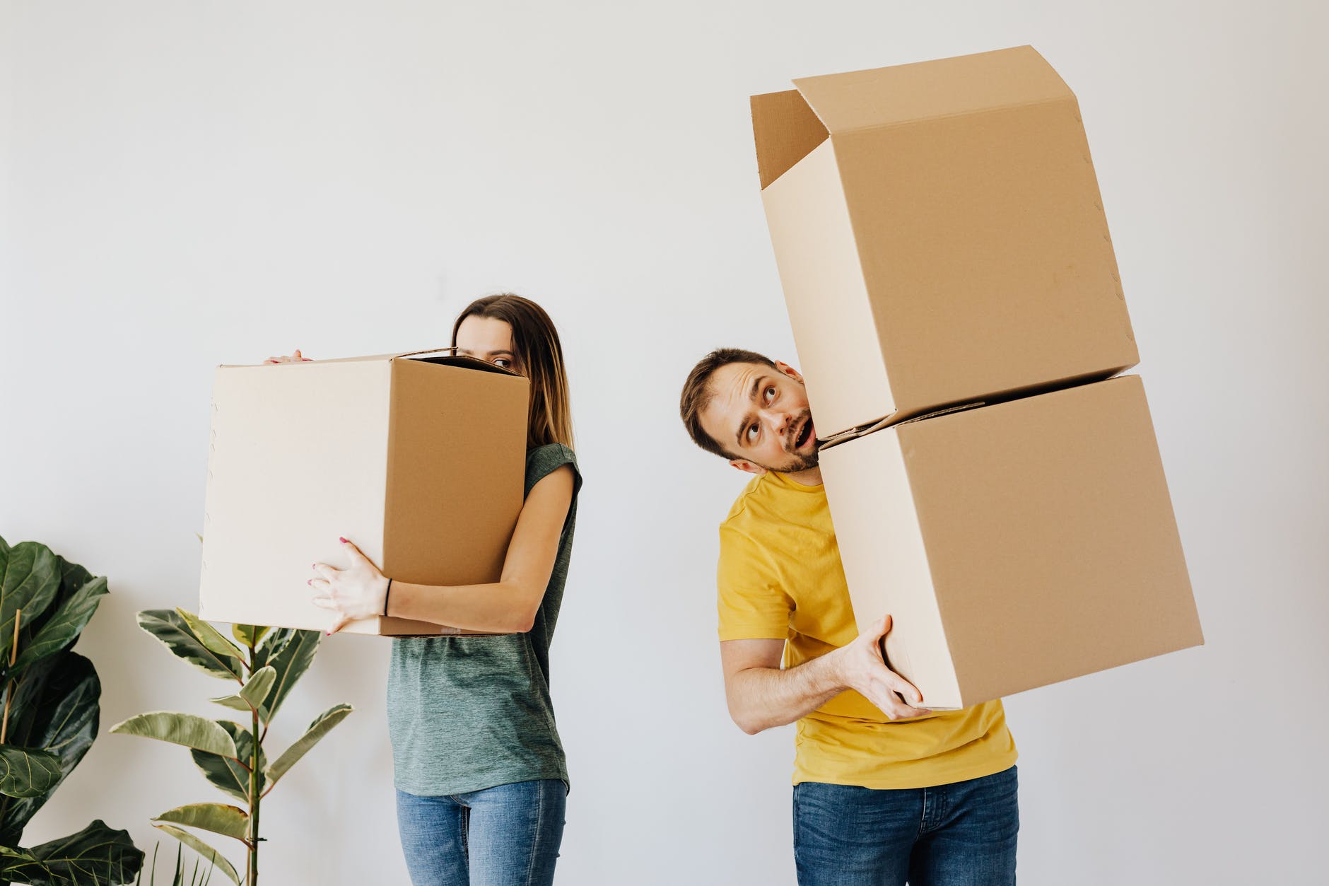 Photo of two people holding large packages